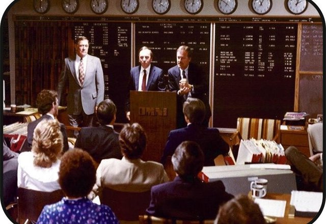 A market briefing beneath the world clocks