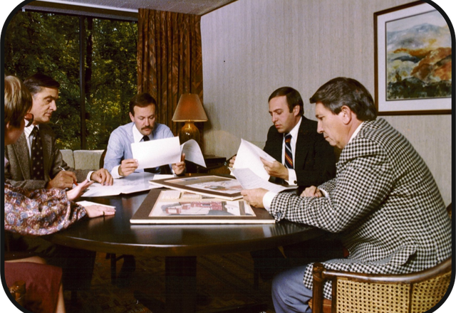 Deal review around the conference table