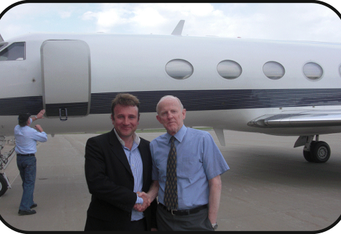 A handshake at delivery beside a Gulfstream